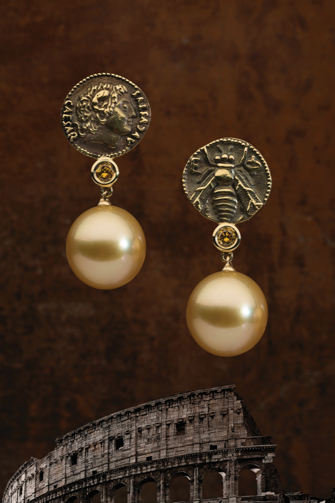 Mediterranean earrings with antique-coin tops and golden South Sea pearls, above the Colosseum