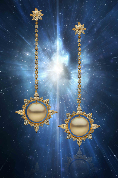 Stars & Galaxies starburst drop earrings with golden South Sea pearls against a starfield
