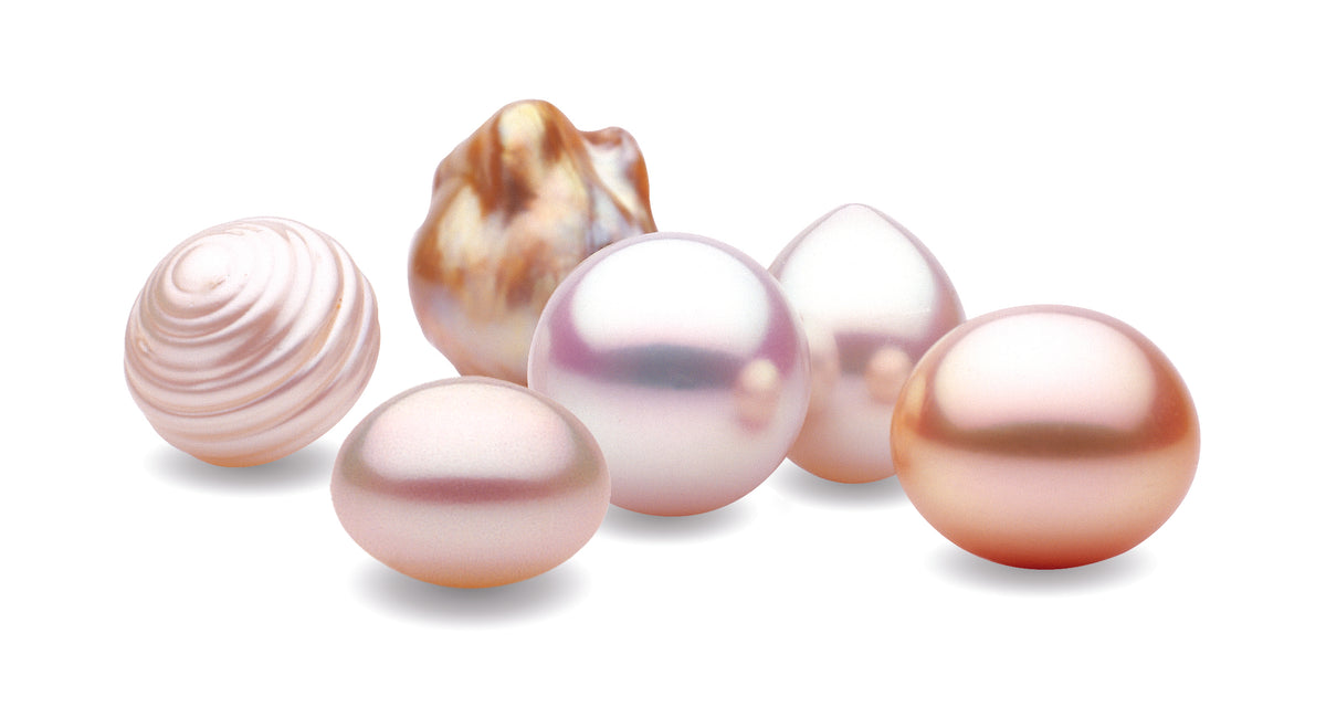 A group of South Sea pearls in varied shapes and shades, from white and pink to deep gold