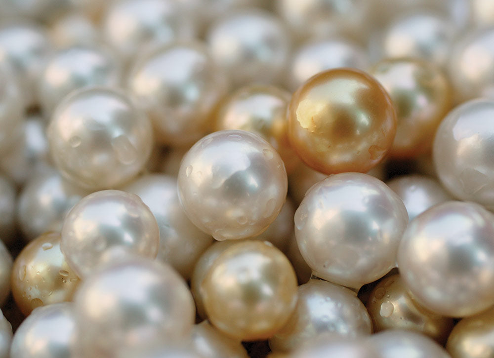 A scattering of white, silver and golden South Sea pearls
